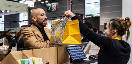 Salon du Chocolat stand with buying visitor.
