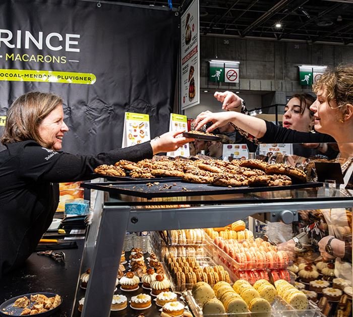 Animated stand at the Salon du Chocolat with visitors discovering chocolate creations.