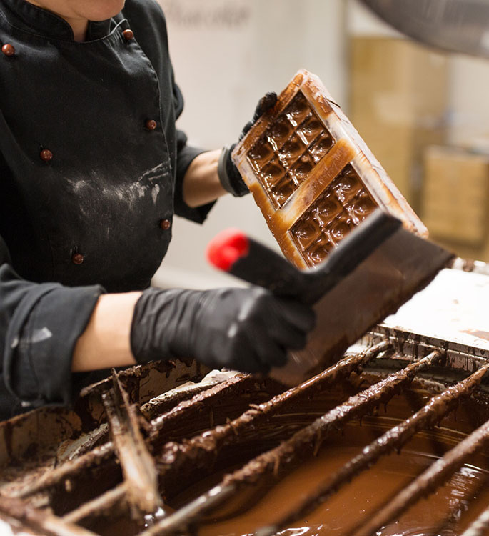 A professional making a chocolate bar.