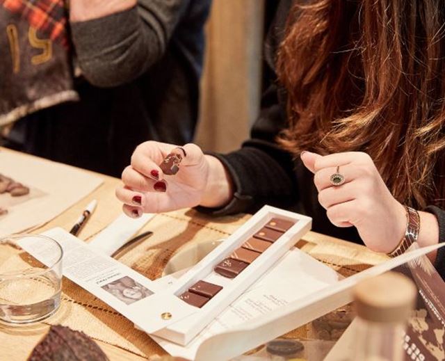 Participants tasting chocolates during a gourmet workshop featuring a selection of chocolate creations