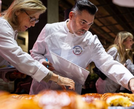 Professional chef jury evaluating pastry creations during a competition