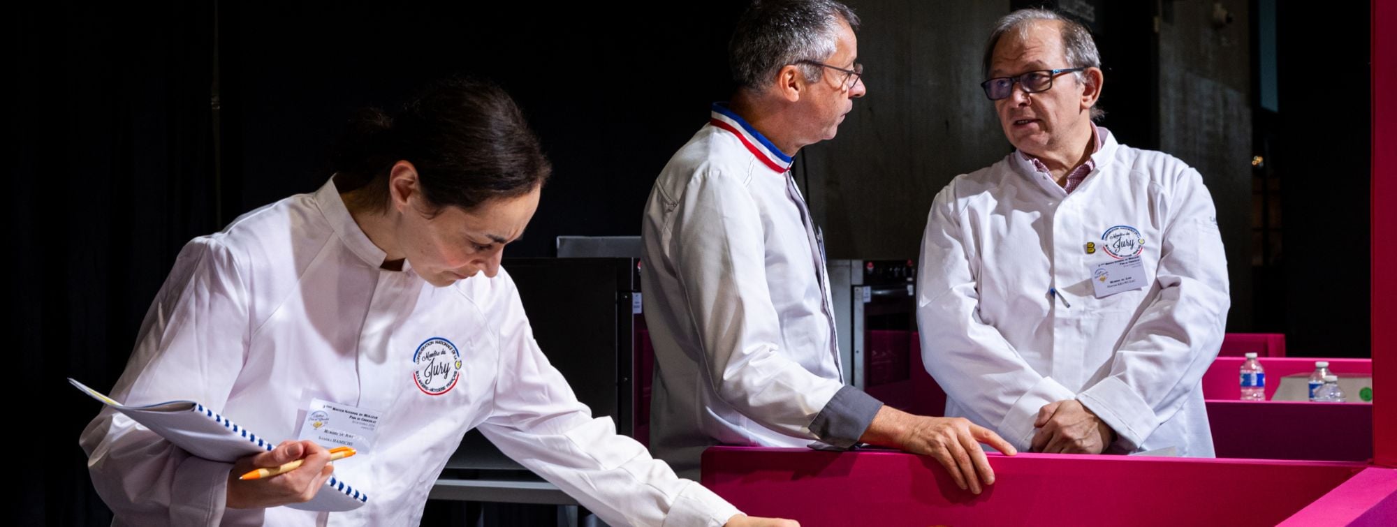 Pastry chefs discussing during a professional pastry competition