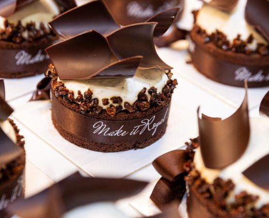 Chocolate cake decorated with chocolate and a ribbon