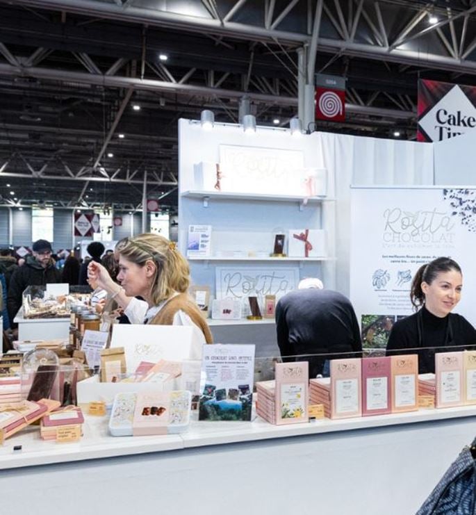 Exhibitor booth at the Chocolate Fair showcasing chocolate creations and gourmet products