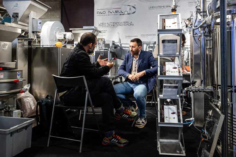 Professionals talking on a stand in the BtoB Village.