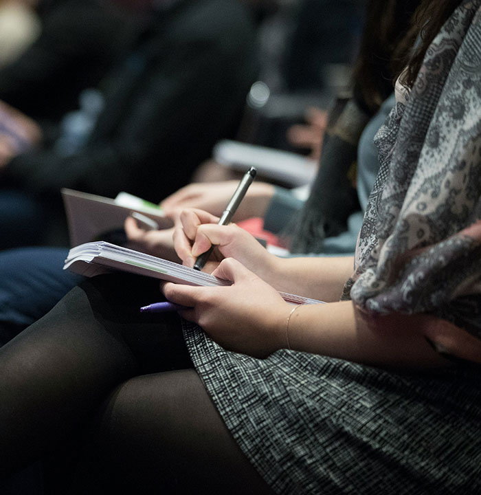 Photo d'une personne en train de prendre des notes sur son carnet. 