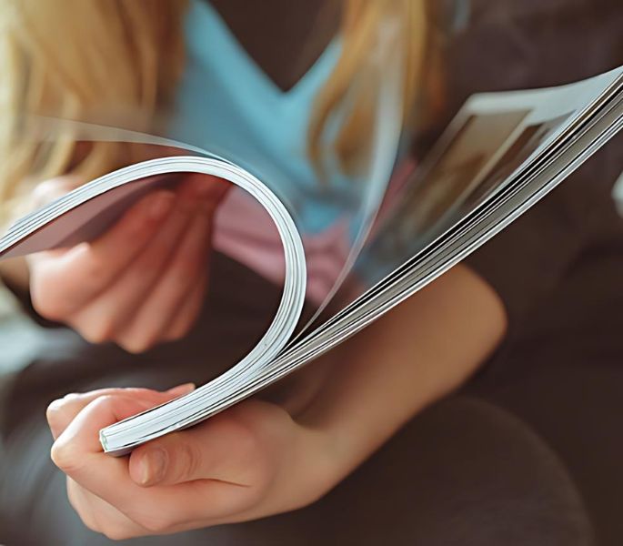 Flipping through a colorful brochure.